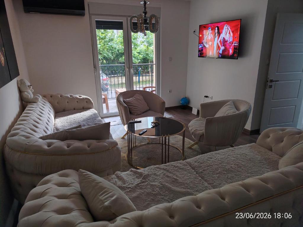a living room with a couch and chairs and a tv at L2 Toplica PK in Prokuplje