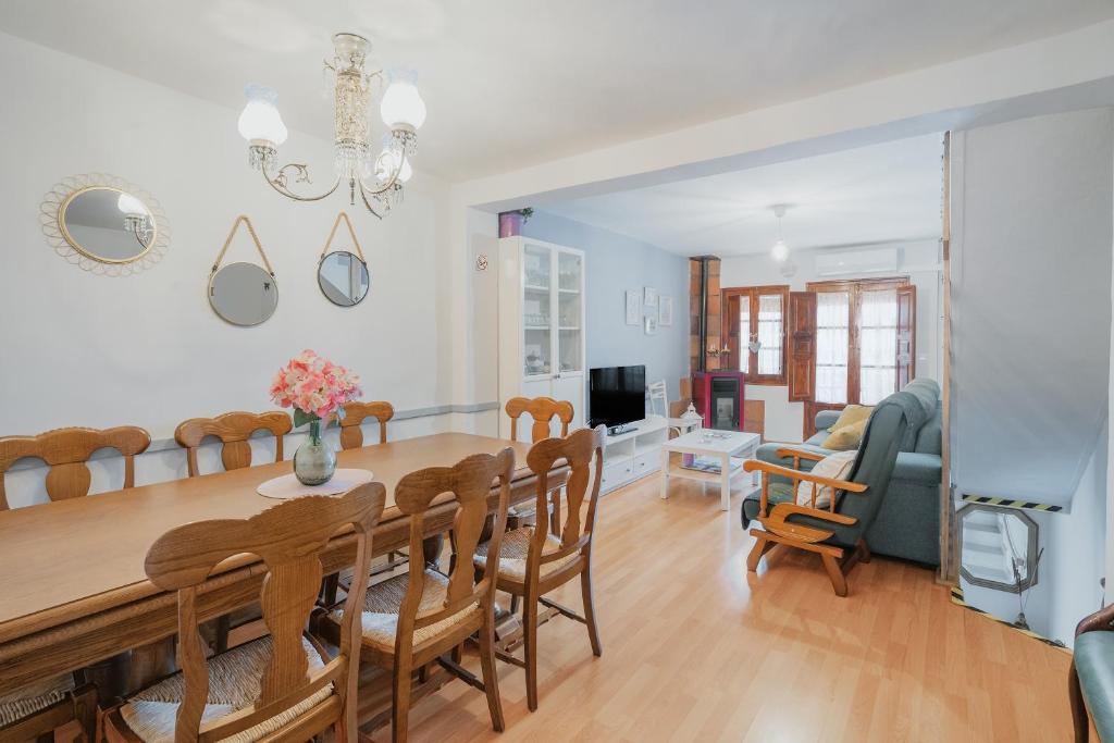 a dining room and living room with a table and chairs at La Casa De La Golondrina in Pedro Bernardo