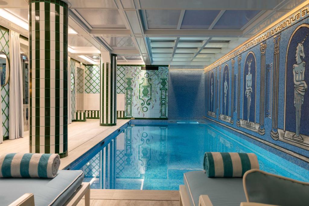 a swimming pool in a room with a pool at Hôtel Le Magnifique Ex Hôtel Le M in Paris