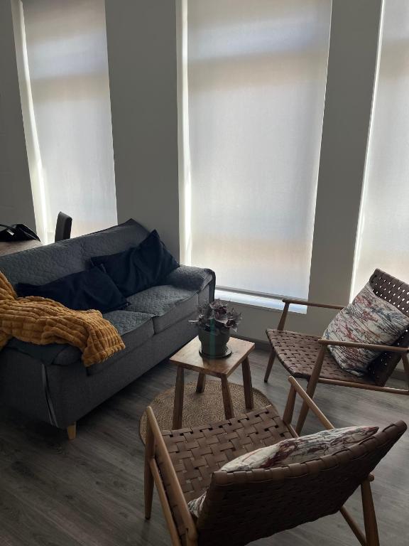 a living room with a couch and a table and chairs at Apartamento Puertu Chicu in Llanes