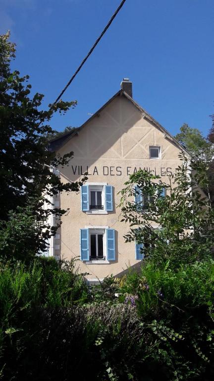 a building with a sign on the side of it at Villa des Familles La Bourboule in La Bourboule