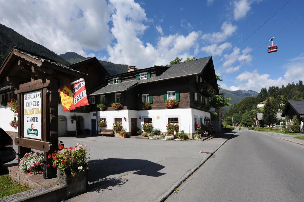 a large building on the side of a road at Pension Backstuba in Partenen