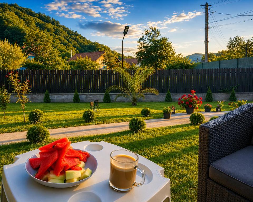 a plate of fruit on a table with a cup of coffee at Grey in Călimăneşti