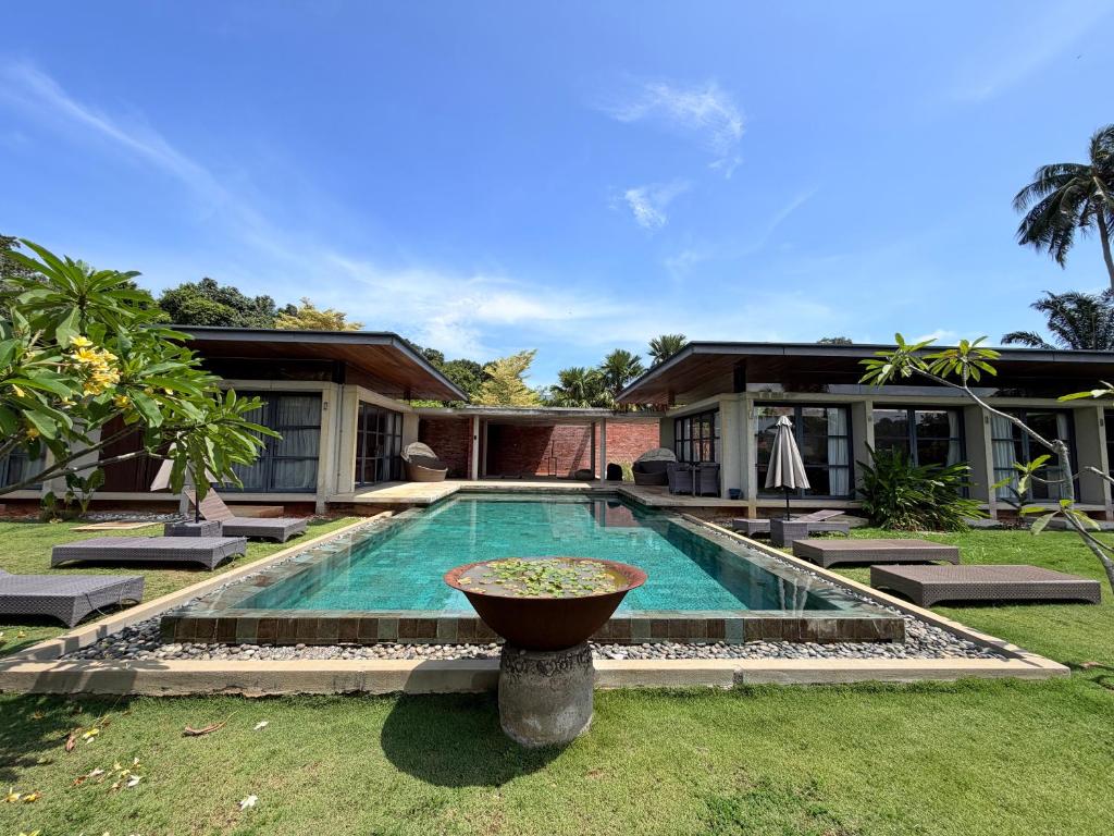 a swimming pool in the backyard of a house at Laman Villa Port Dickson in Port Dickson