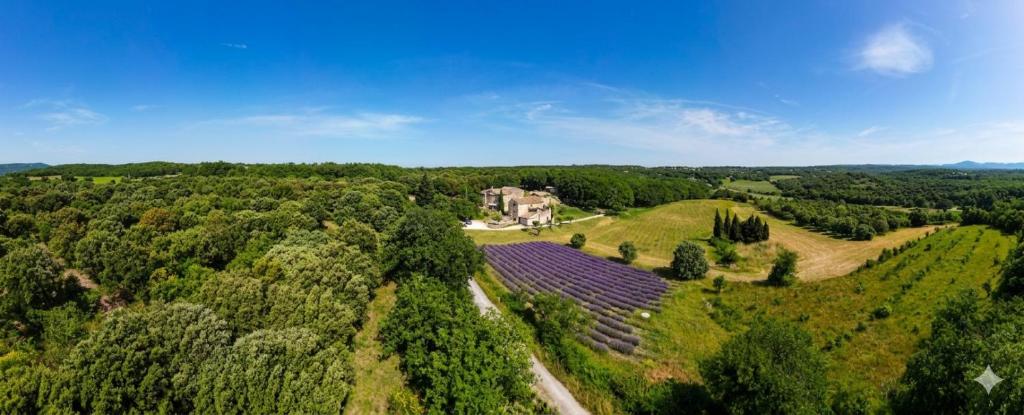 an aerial view of a house in the middle of a field at La Ferme les Eybrachas in Réauville
