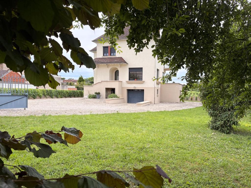 a large white house with a grass yard at VILLA 87 - AY CHAMPAGNE in Ay
