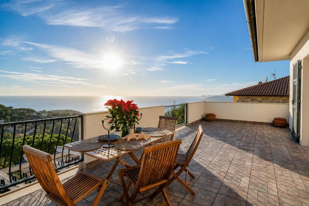 a patio with a table and chairs on a balcony at Casa Aldrovandi in Capoliveri