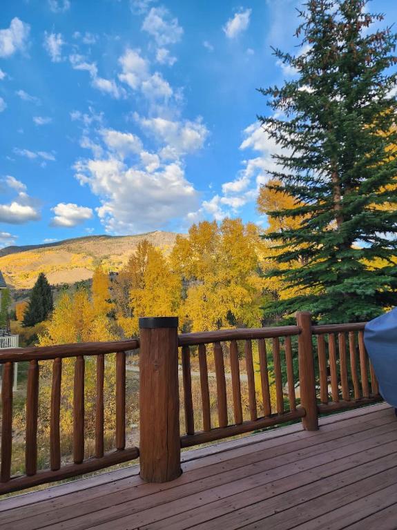 a wooden deck with a view of the fall foliage at Townhome 4BR/4BA in Silverthorne in Silverthorne