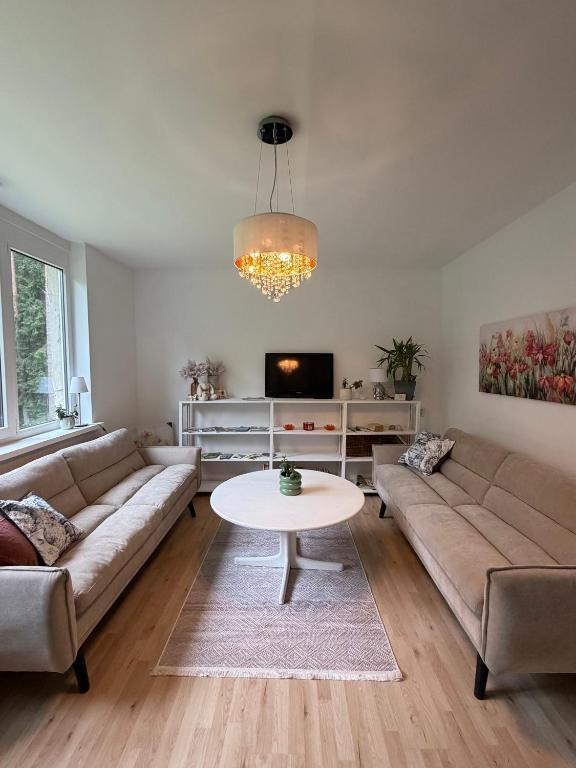 a living room with a couch and a table at Apartment with sauna and fireplace in Viitna