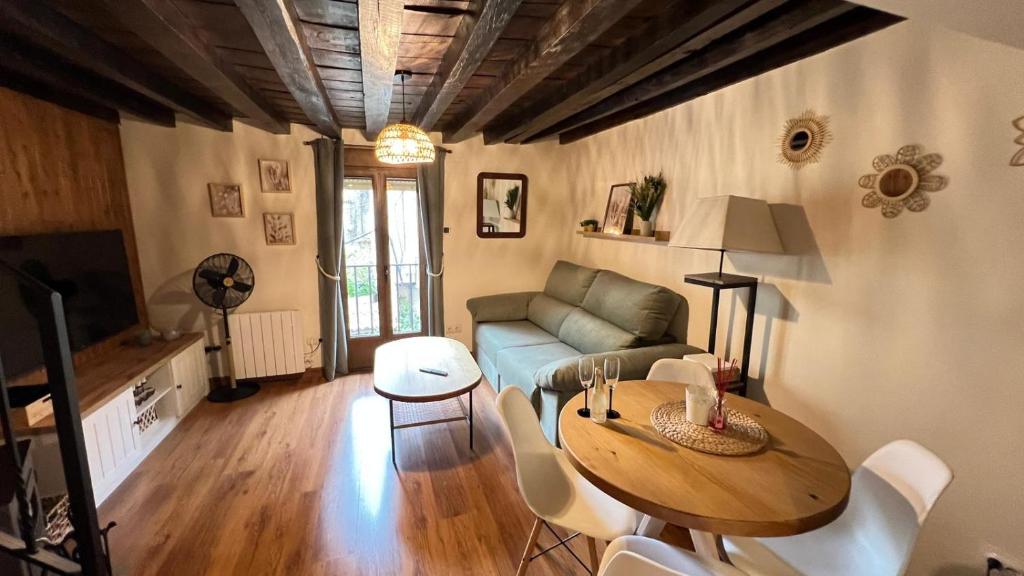 a living room with a table and a couch at Las Casitas de Martín in Candeleda