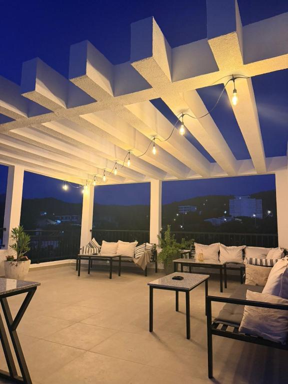 a room with couches and tables on a roof at Apartments Tina in Utjeha