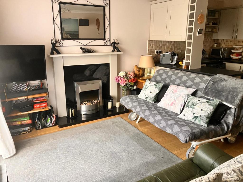 a living room with a couch and a fireplace at ChezVous in Swords