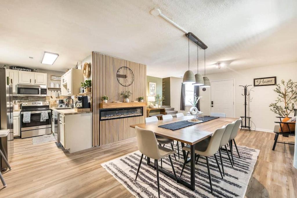 a kitchen and dining room with a table and chairs at Charming Farmhouse Getaway 7 Beds in Centerville