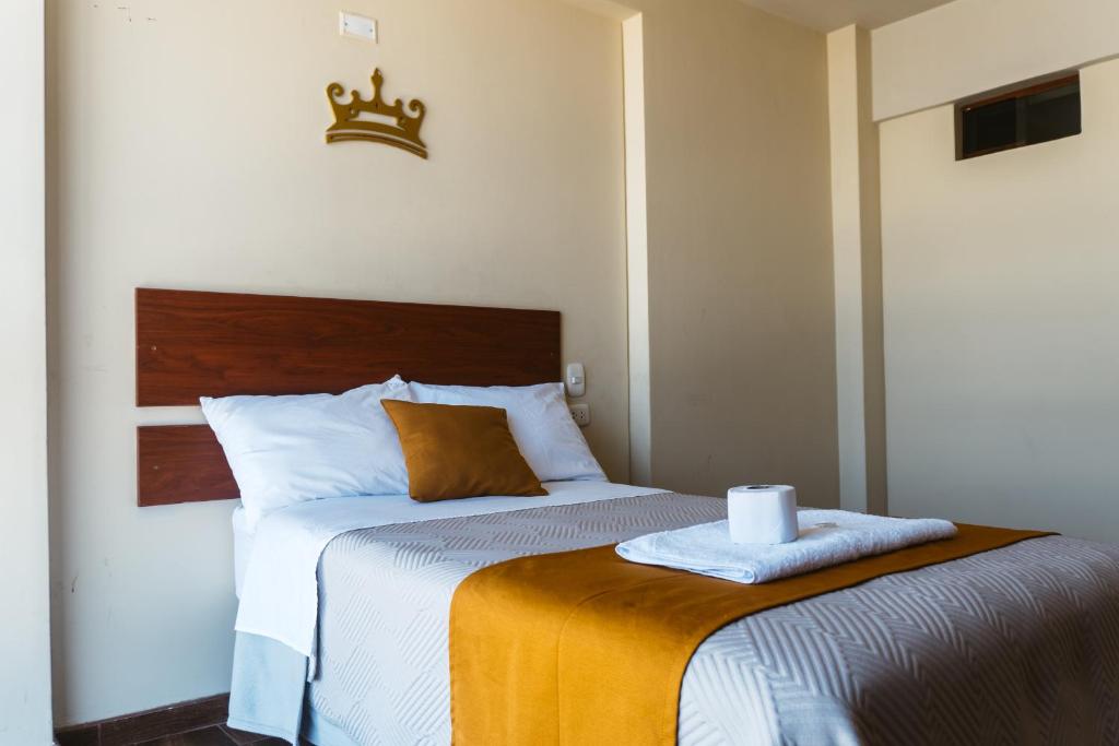 a bedroom with a bed with a crown on it at El Sueño Del Rey in Majes