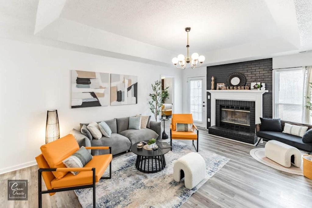 a living room with a couch and a fireplace at Madison Luxury 4BR Theater Arcade Firepit in Madison