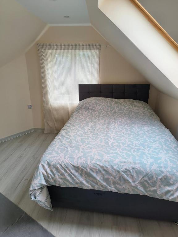 a bed in a room with a window at Yunus in Croydon