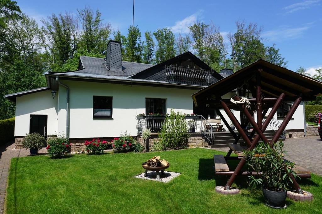 a house with a yard with a fire pit at Live your dream in Kirchberg