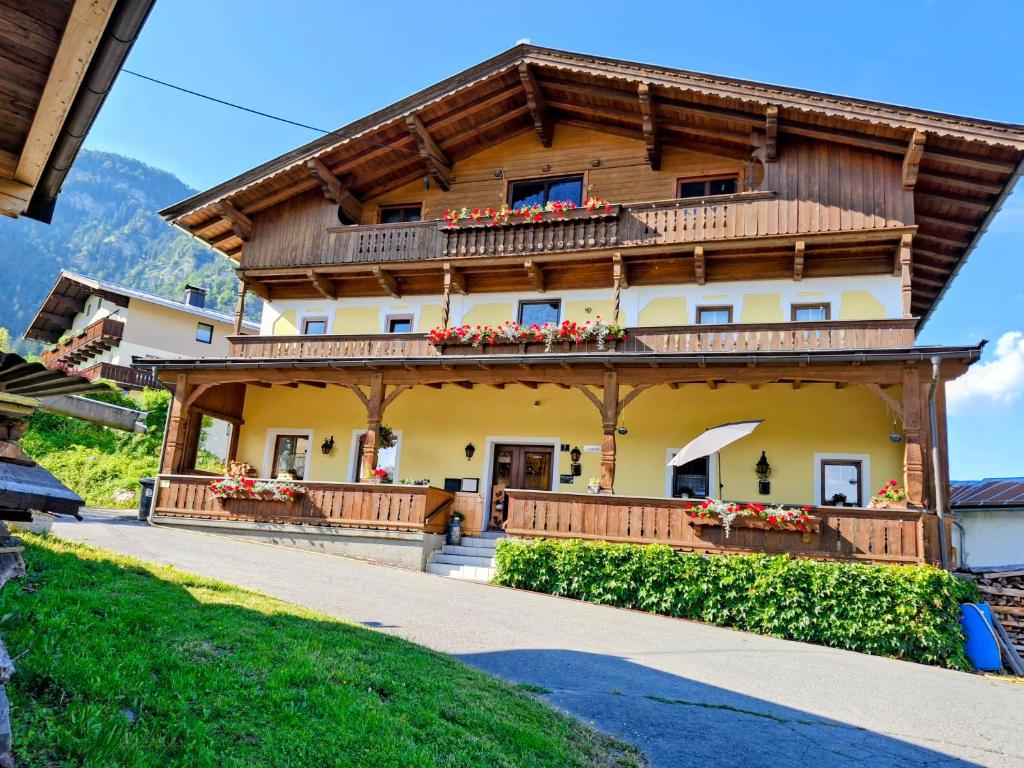 a house in the mountains with flowers on the balcony at Lampererhof in Sankt Johann in Tirol