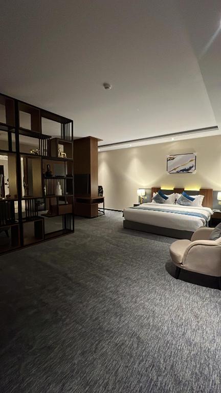 a large bedroom with a bed and a book shelf at Belvedere Hotel in Medina
