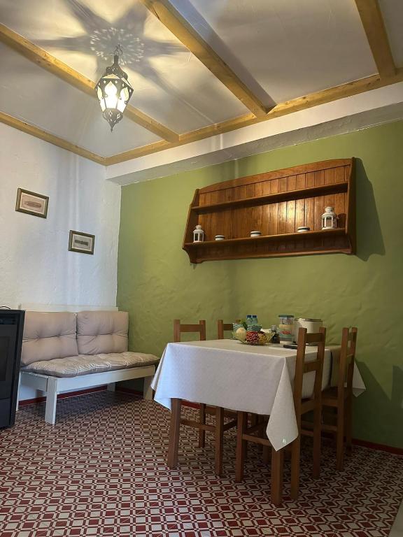 a living room with a table and a couch at Casa tio Manuel in São Martinho das Amoreiras