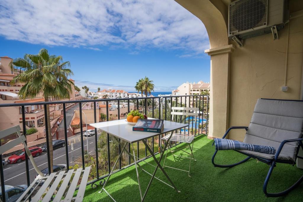 a balcony with a table and chairs and a view at Noemi Blu Tenerife in Los Cristianos