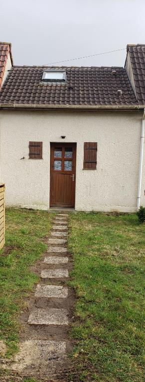a house with a door and a grass yard at Maison in Camiers