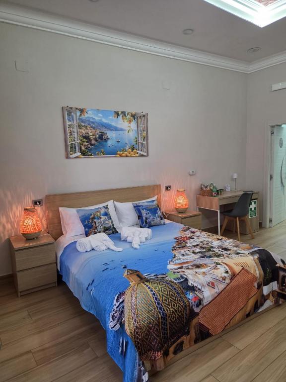 a bedroom with a large bed with a blue comforter at Maison de Ciro in Gragnano