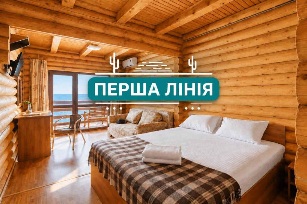 a bedroom with a bed in a wooden room at Ensenada in Gribovka