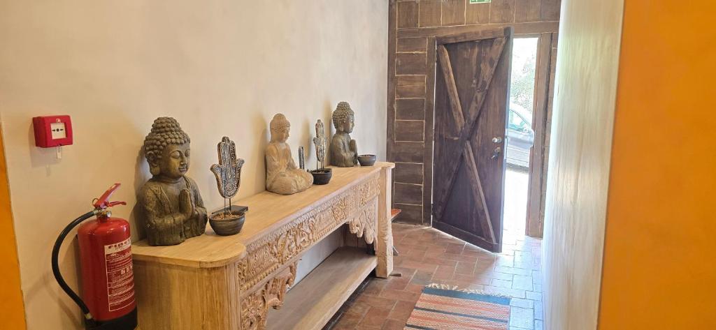 a room with a fireplace with statues on it at Havana Hostel in Albufeira