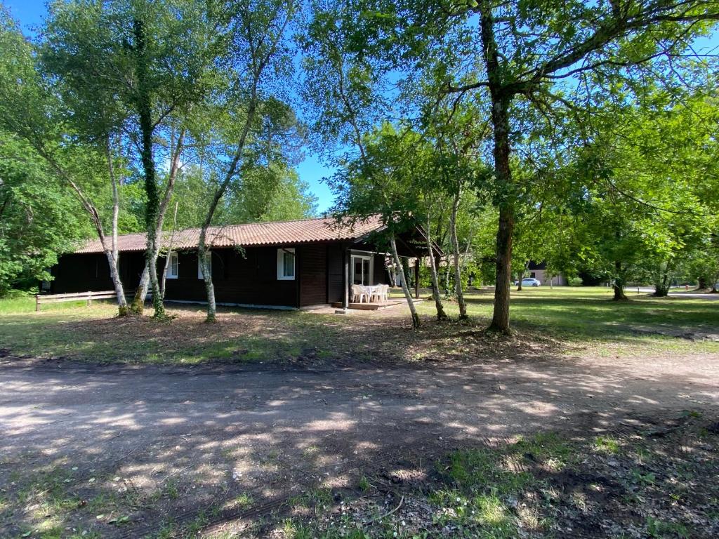 a log cabin with trees in front of it at Fre&dom in Lacanau