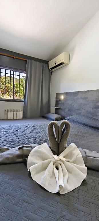 a bedroom with a large bed with a large white dress at new bv carlos paz in Villa Carlos Paz