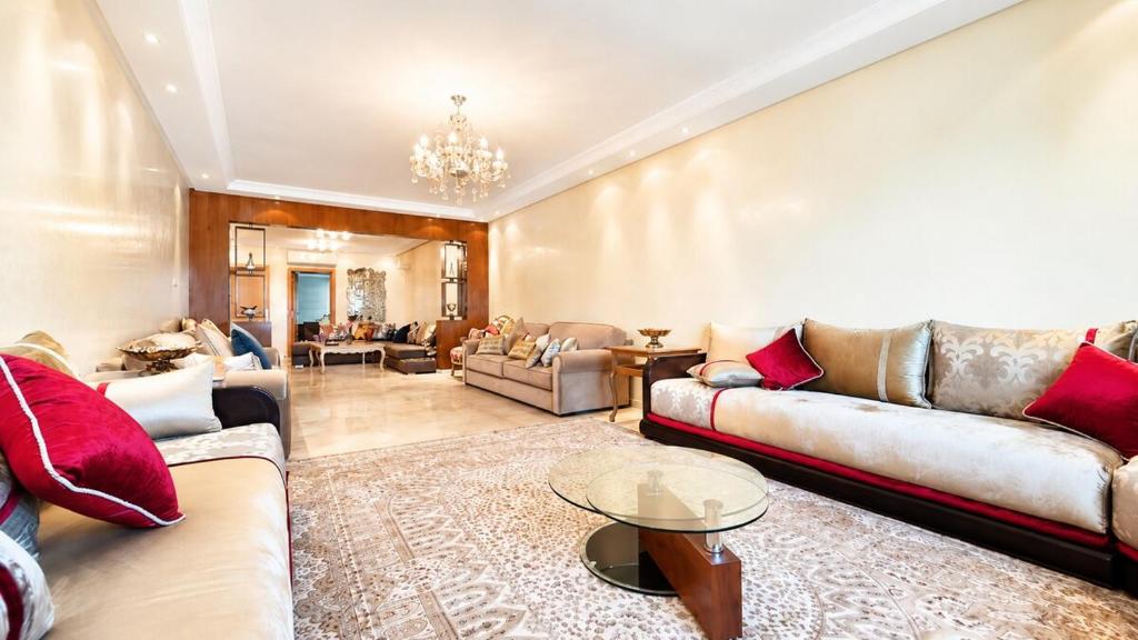 a living room with couches and a table at Luxury family apart parc plaza Mohammedia in Mohammedia