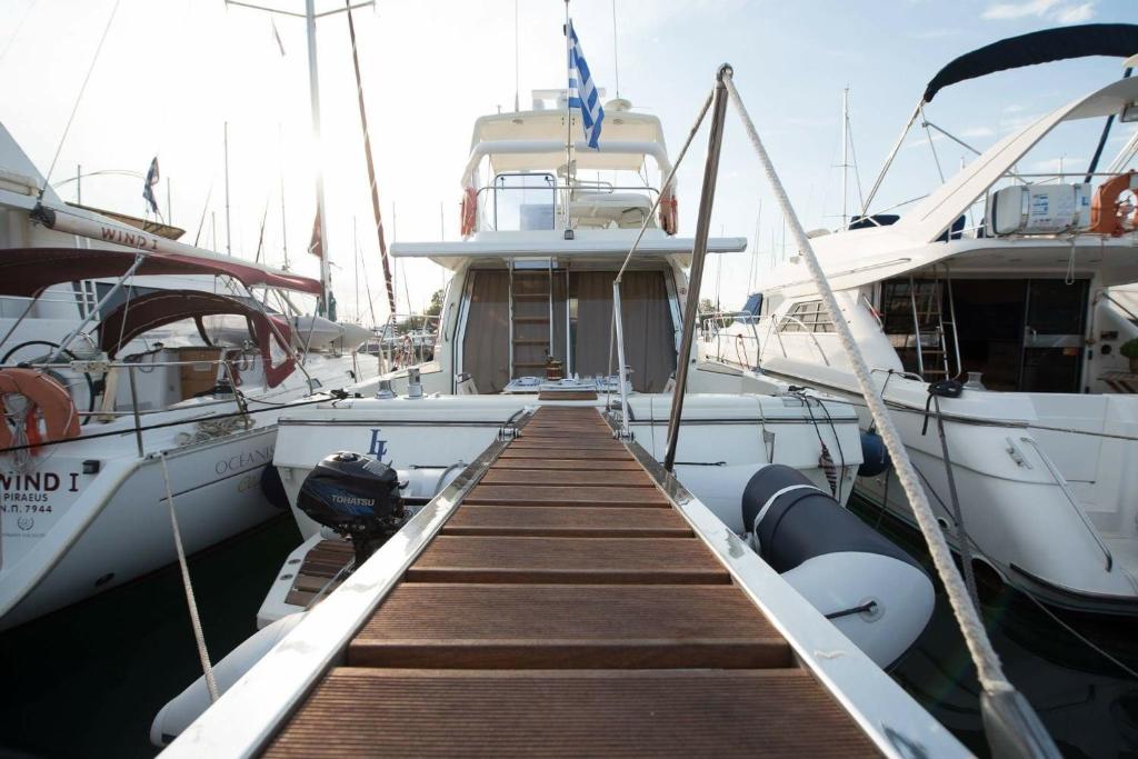 a dock with several boats docked in a harbor at Solymar Greece Yachting. m/y "LL" in Athens