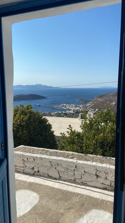 a view of the ocean from a window at John's View in Serifos Chora