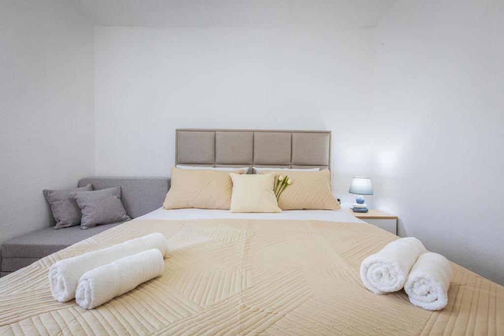 a bedroom with a large bed with towels on it at Markovi A&V in Gevgelija