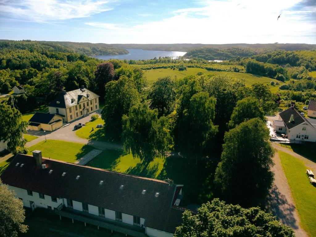 an aerial view of a large house with a field and trees at Hensbacka Hotell in Munkedal