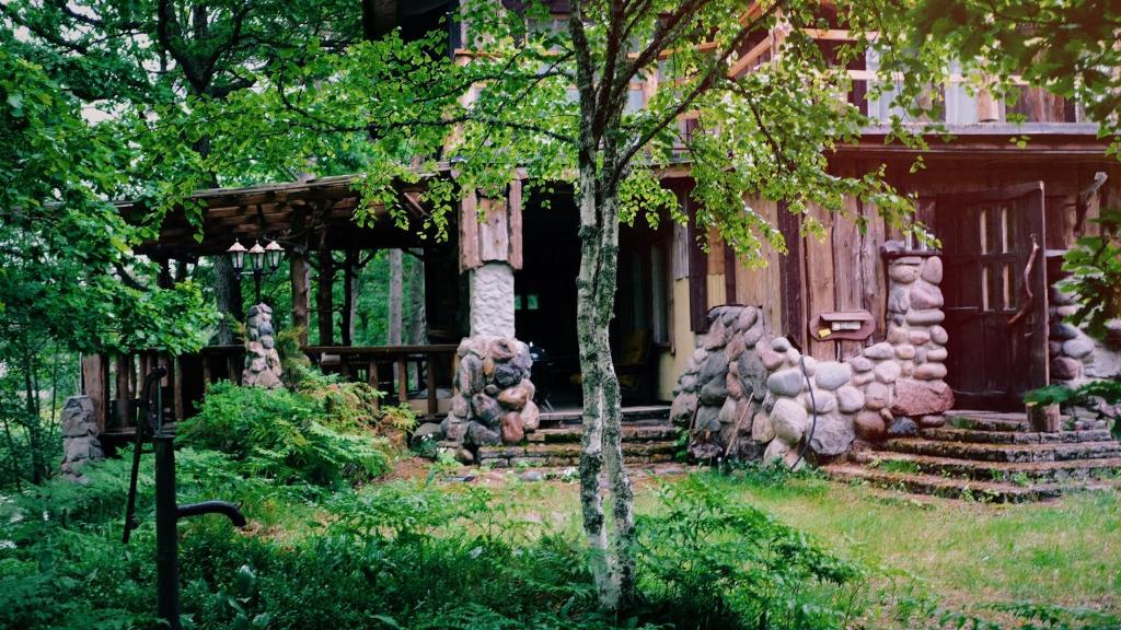 a house with a bunch of statues in front of it at Finstonia Guesthouse in Vääna-Jõesuu
