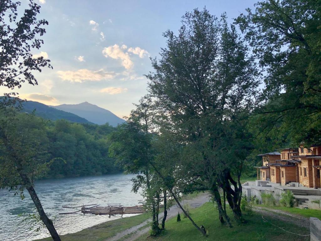 a view of a river with trees and buildings at Tara Rafting Resort in Foča