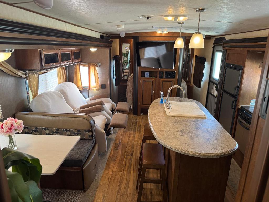 an rv with a kitchen and a living room at Florida VIBE in Homosassa Springs