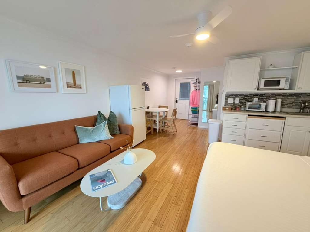 a living room with a couch and a table at Surfside - Boutique Studio Condo with Pool in Hampton