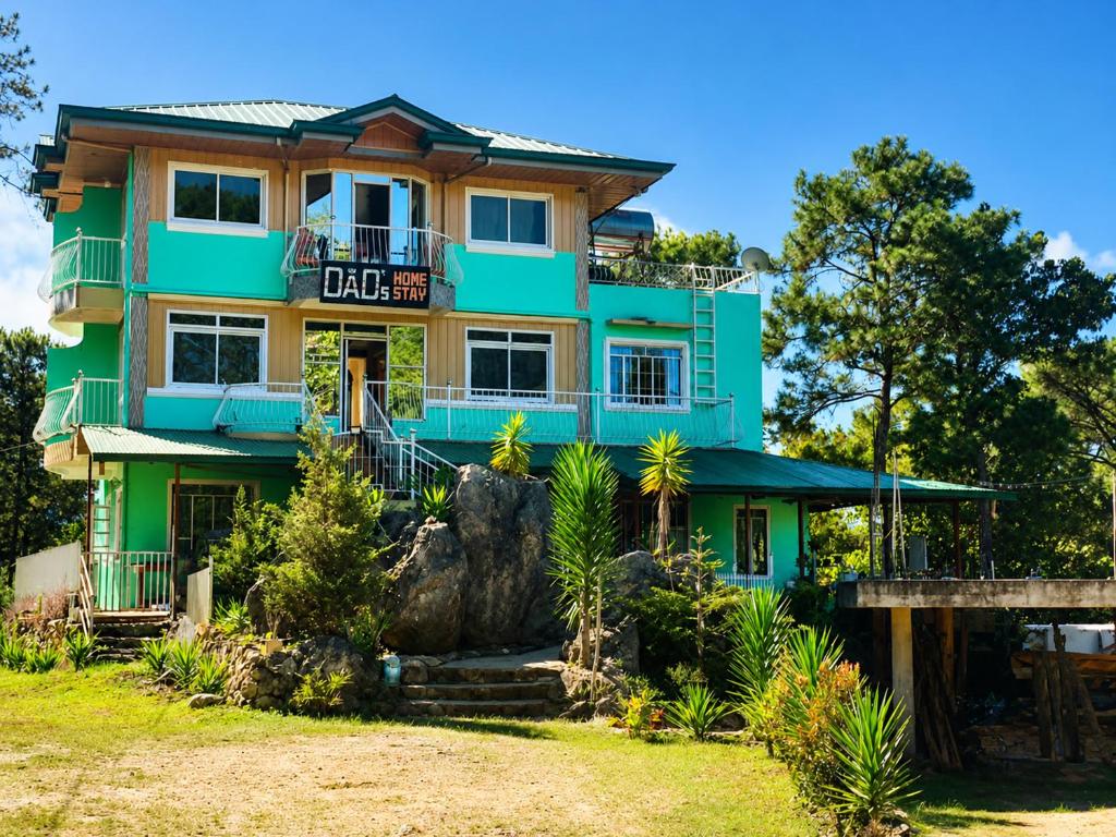 a green house with a large rock in front of it at 3 Mins Drive to Marlboro Hills - Sagada Dad's Homestay in Sagada