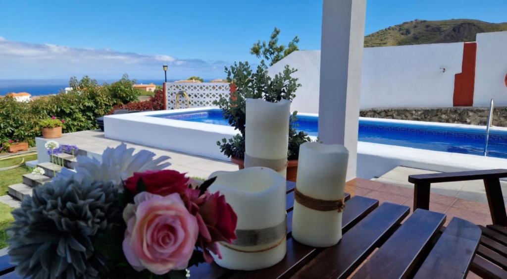 a table with candles and a bouquet of flowers on it at Casas Hoya Limpia- Sólo Adultos in Santa Cruz de la Palma
