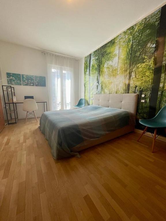 a bedroom with a bed and a painting on the wall at Fabio's Home in Bassano del Grappa