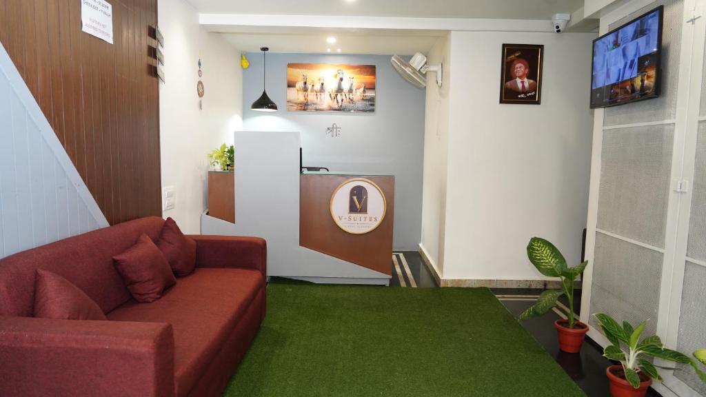 a living room with a couch and a tv at V-Suites in Bangalore