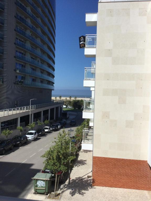 a view from the balcony of a building with a parking lot at HabiKuchta Foz in Figueira da Foz