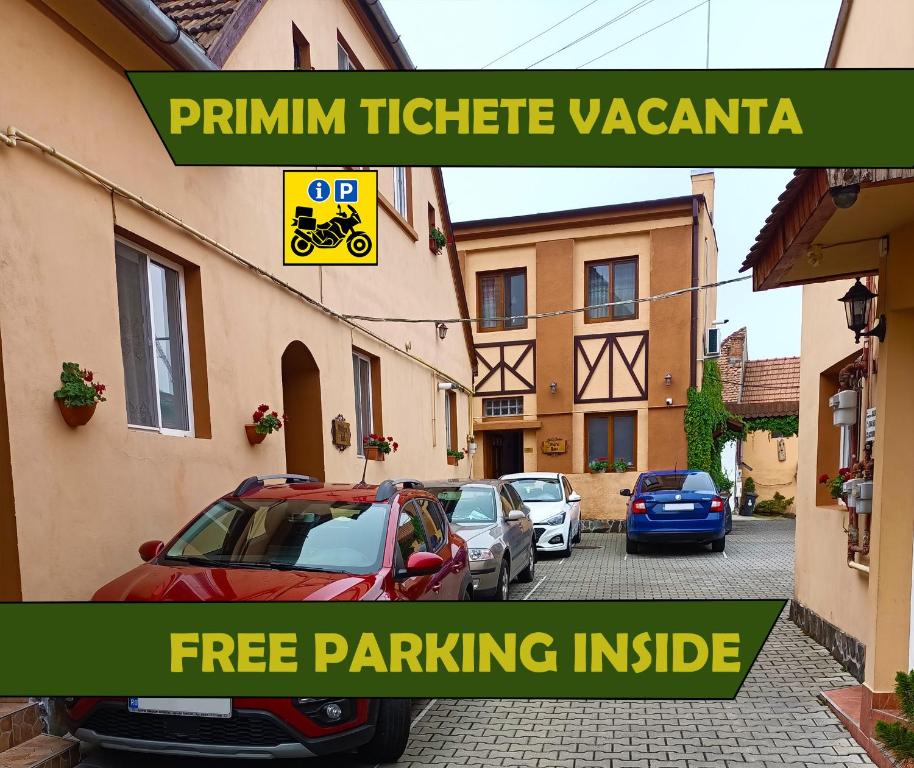 a group of cars parked in a parking lot at Pensiunea Casa Sighisoreana in Sighişoara