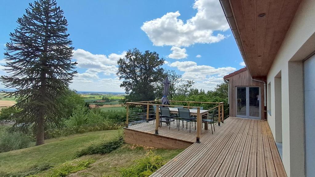 a wooden deck with a bench on top of a house at Merveille du Mont in Météren