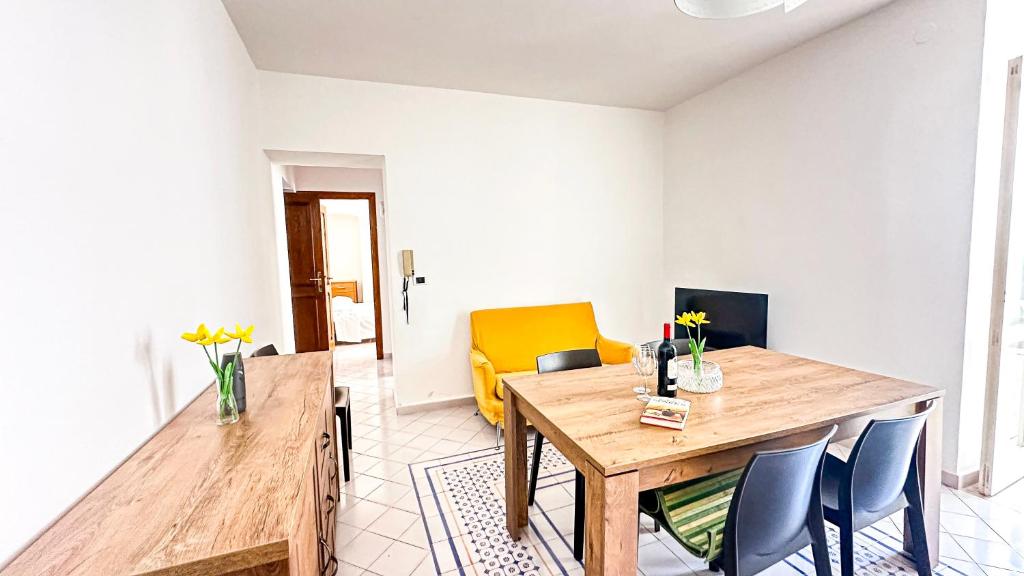 a dining room with a wooden table and chairs at Acquafredda Ritrovata in Acquafredda