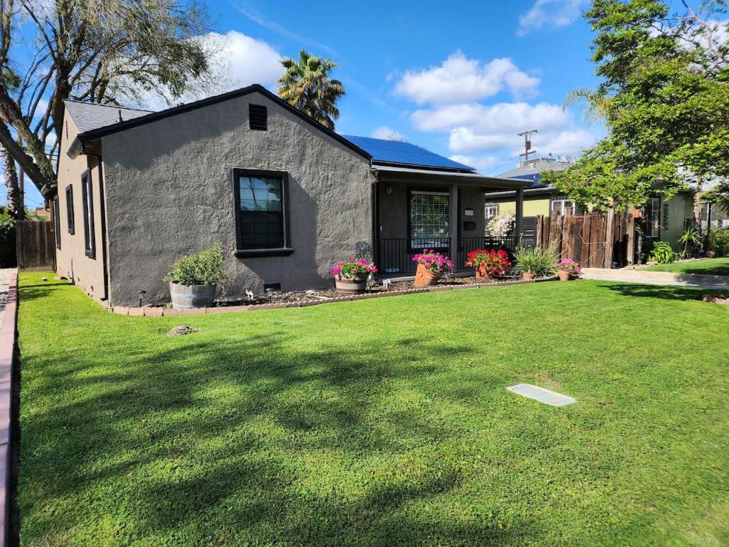 a house with a lawn in front of it at 21 Cozy Home in the Heart of the City in Stockton