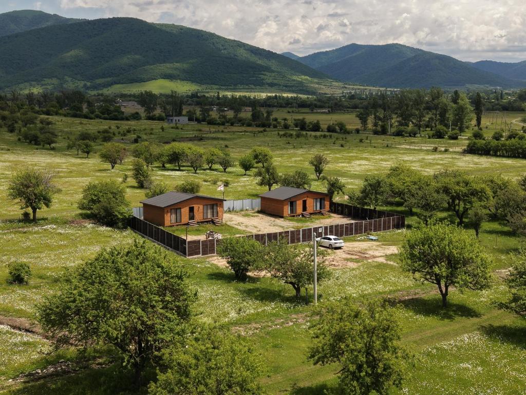 an aerial view of a house in a field at Tianeti Apple Cottages in Churchelaurebi